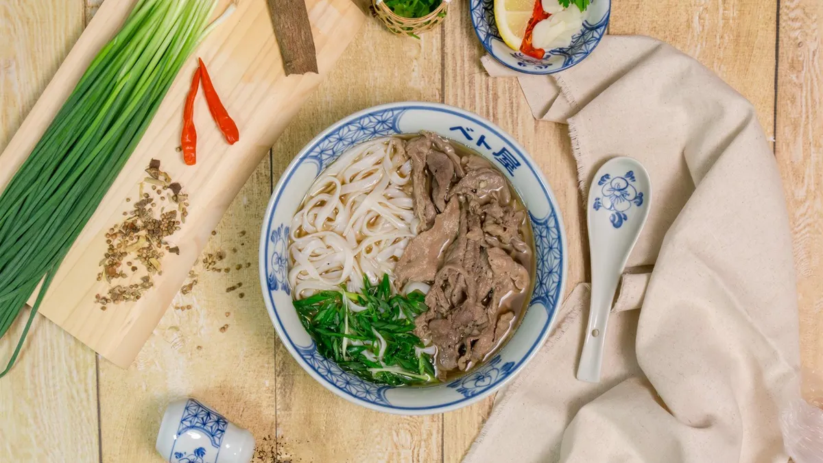 香草とライムを添えたベト屋のフォー一杯